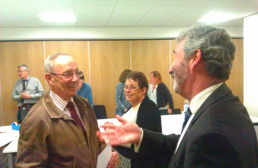 Walter Sanger (left) being congratulated by Alec Robertson, the Council Leader